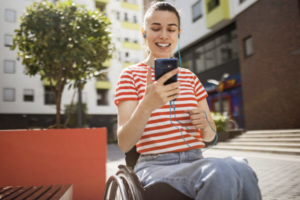 girl in a wheelchair listening to an audio guide with earbuds