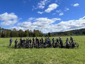 Group of people in grass using adaptive mountain bikes