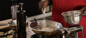 Hand mixing flour in a bowl