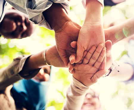 group of hands together in a group circle