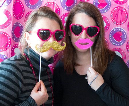 event guests wearing heart glasses and funny mustaches