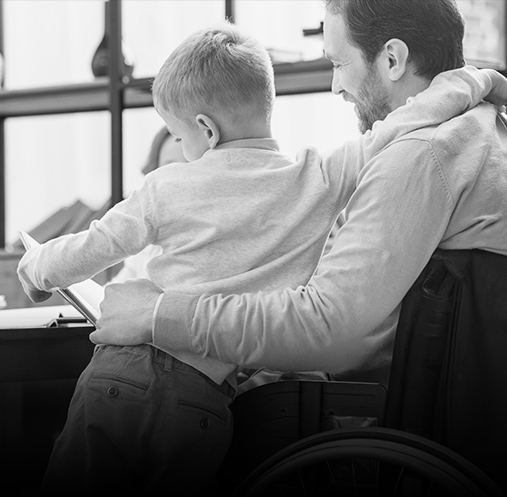 Man in wheelchair with son reading