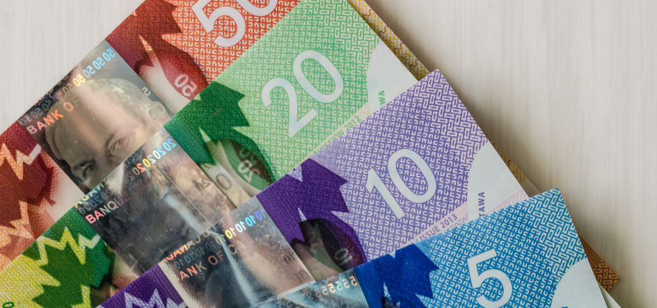Canadian currency fanned out including a 5, 10, 20 and 50 dollar denomination