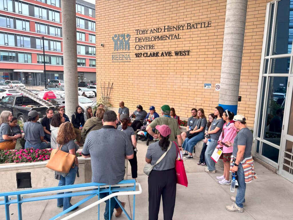 individuals in front of Lou Fruitman