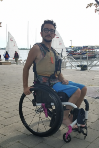 Man using wheelchair by harbour front