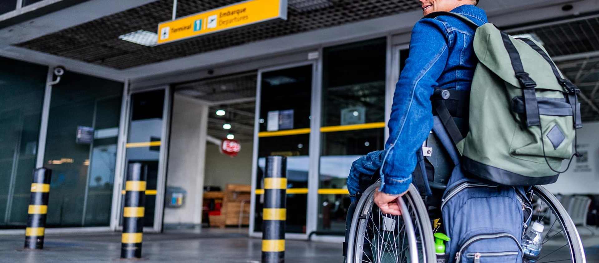 Mature man using a wheelchair arriving on airport