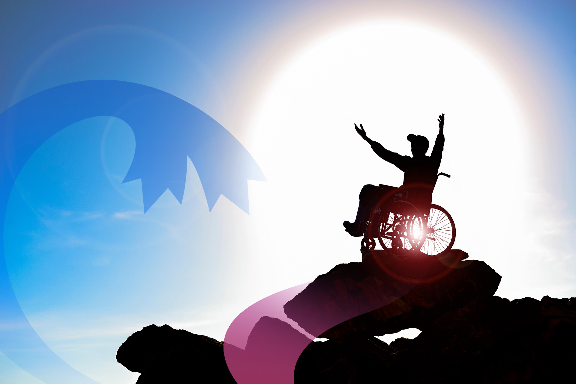 man in a wheelchair on top of a mountain, arms upraised, silhouetted by the sun
