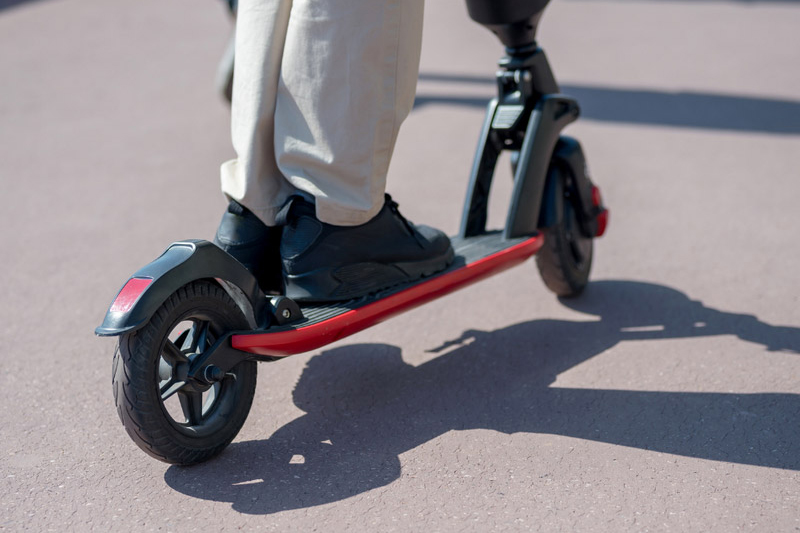 closeup of person riding an e-scooter