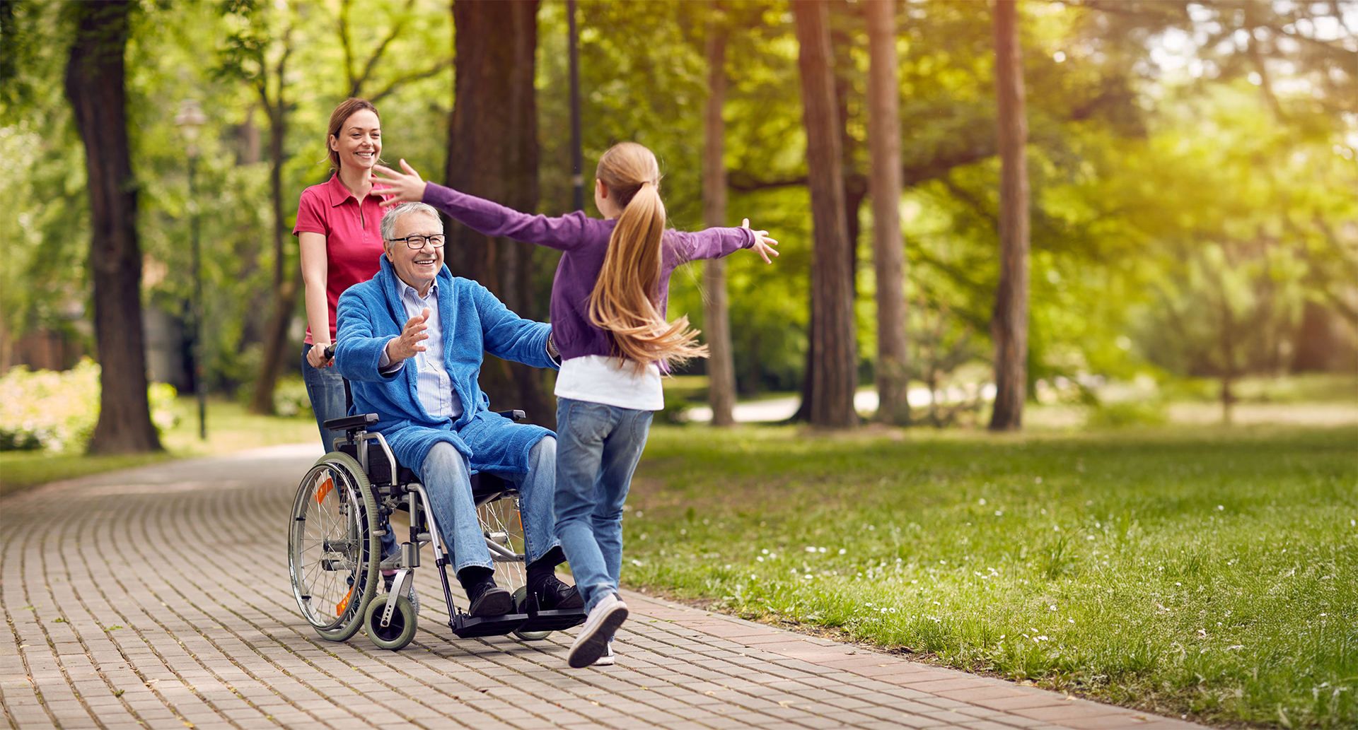 Cheerful disabled grandfather in wheelchair welcoming his granddaughter stock photo.
