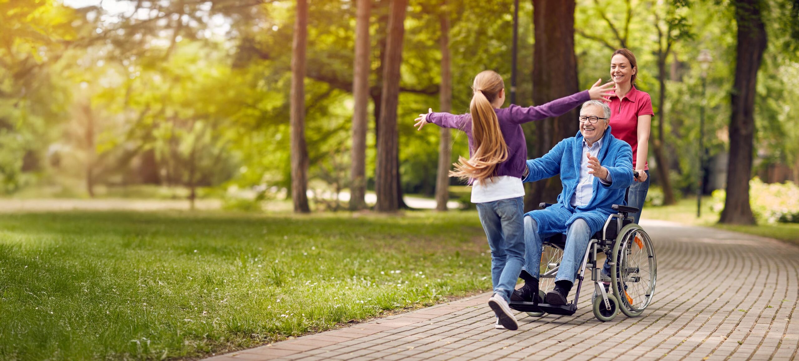 Cheerful disabled grandfather in wheelchair welcoming his granddaughter stock photo