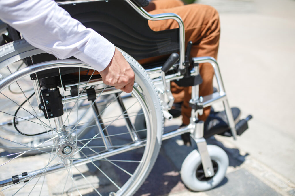 Closeup of a man using a manual wheelchair