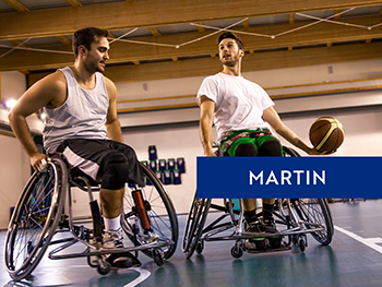 Two young men playing wheelchair basketball.