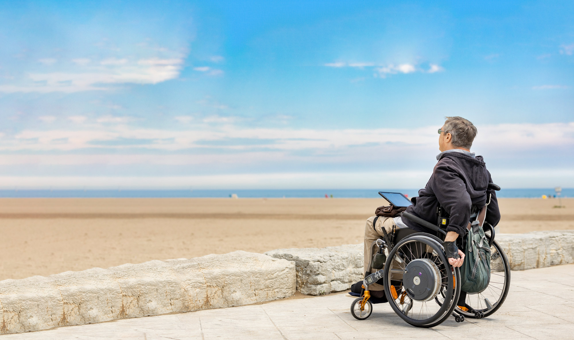 Man at beach in wheel chair