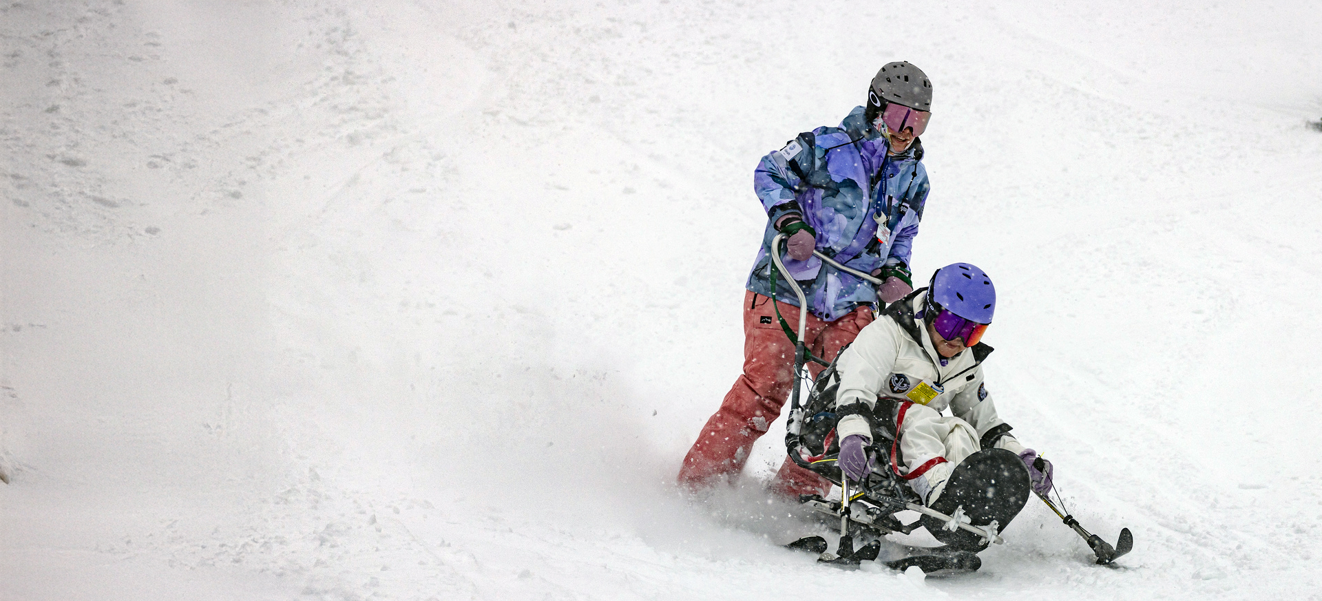 sit-skier and assistant