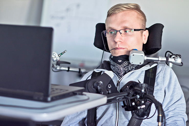 student wheelchair user working with laptop